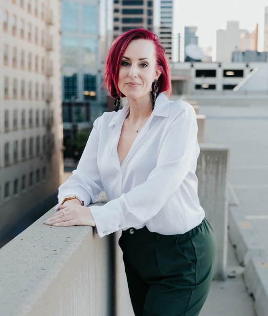 woman taking branding photos downtown Salt Lake City on top of a building