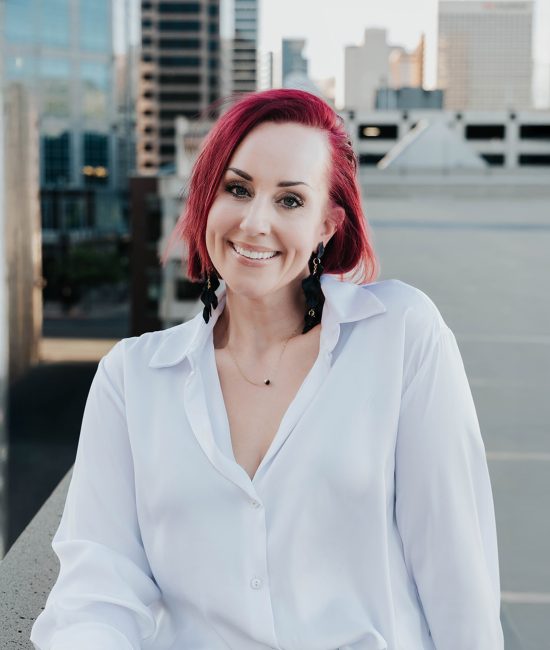 woman taking branding photos downtown Salt Lake City on top of a building