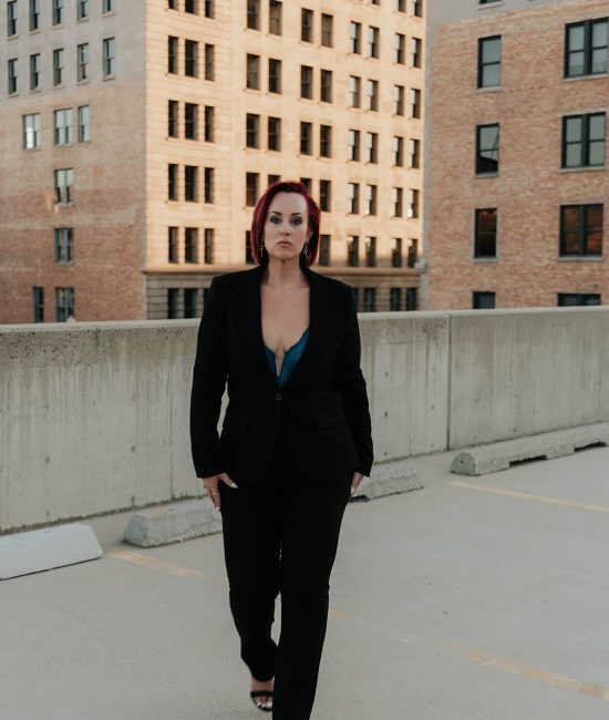 woman taking branding photos downtown Salt Lake City on top of a building