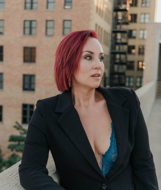woman taking branding photos downtown Salt Lake City on top of a building