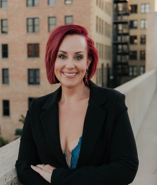 woman taking branding photos downtown Salt Lake City on top of a building