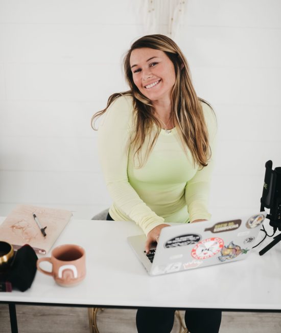 a woman typing on her computer