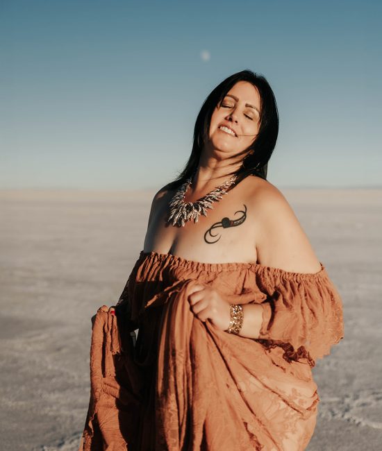 Woman in an orange dress dancing on the Salt Flats