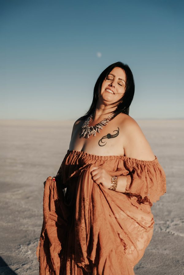 Woman in an orange dress dancing on the Salt Flats